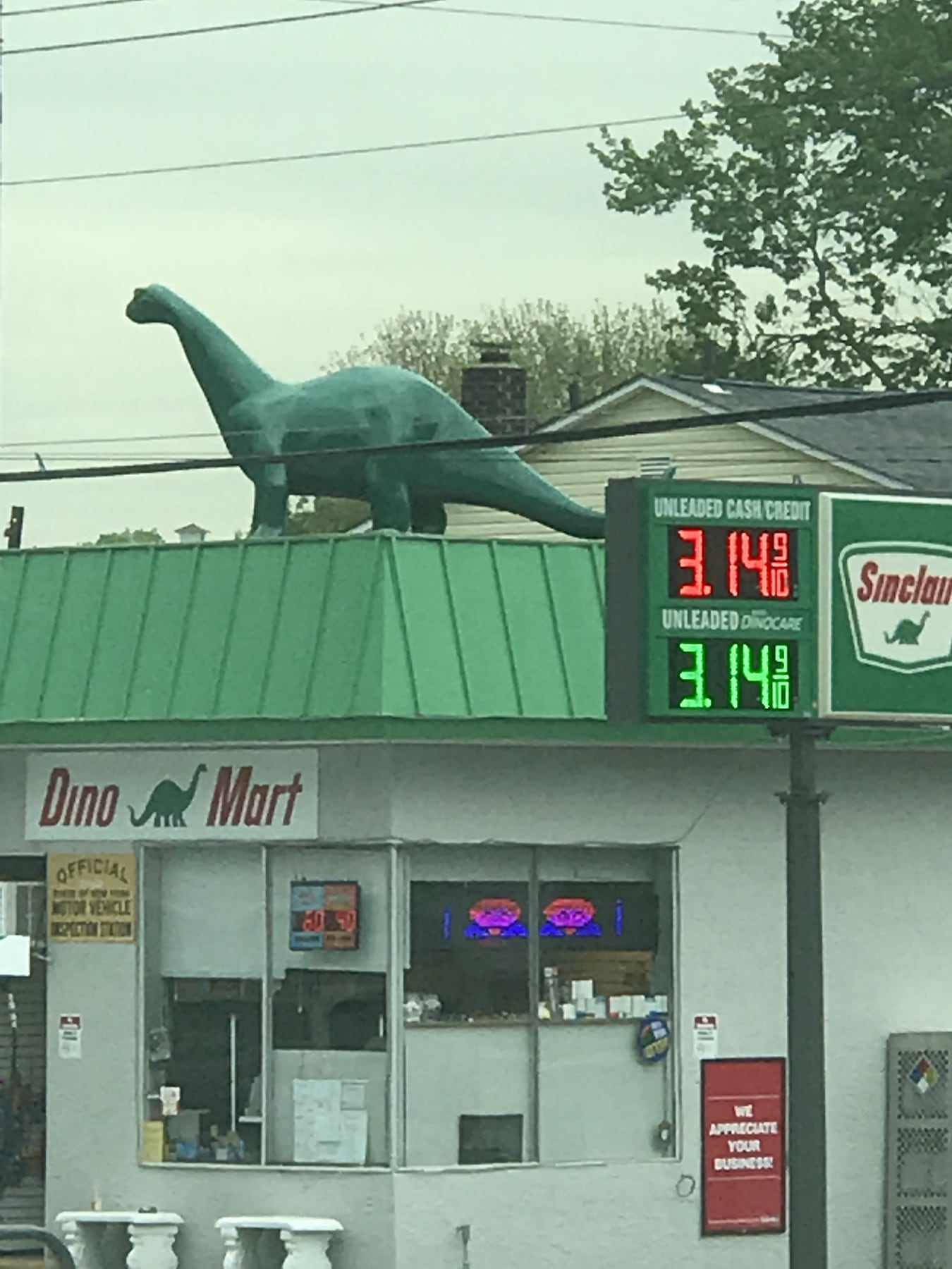 Dino Mart sign and Sinclair dinosaur on the shop roof